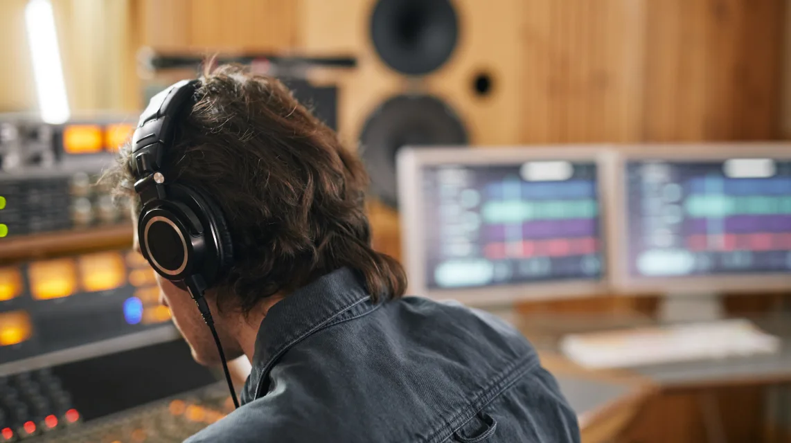 Recording studio with mixing desk and monitors during a production session
