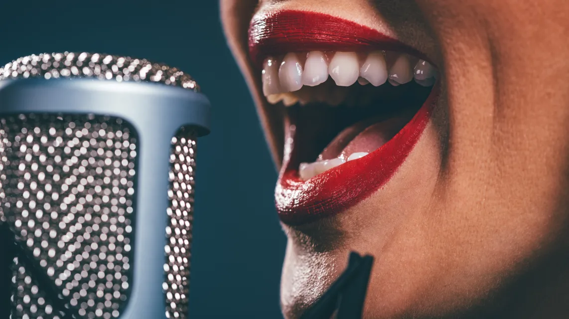 Close-up of a singer performing into a studio microphone