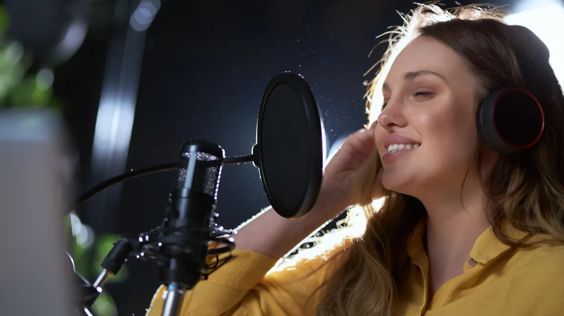Singer recording a vocal take in a professional studio