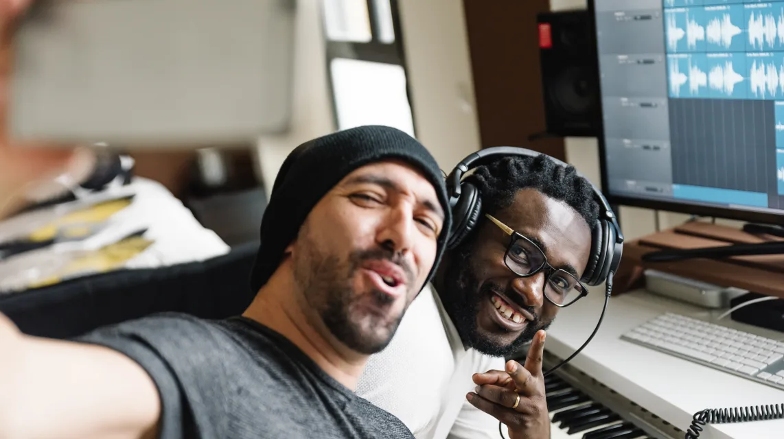 Artists working on music together in a home studio
