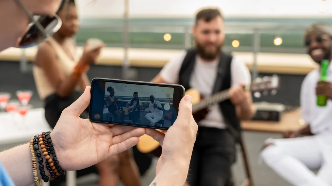 Musicians filming a vertical video clip on a phone